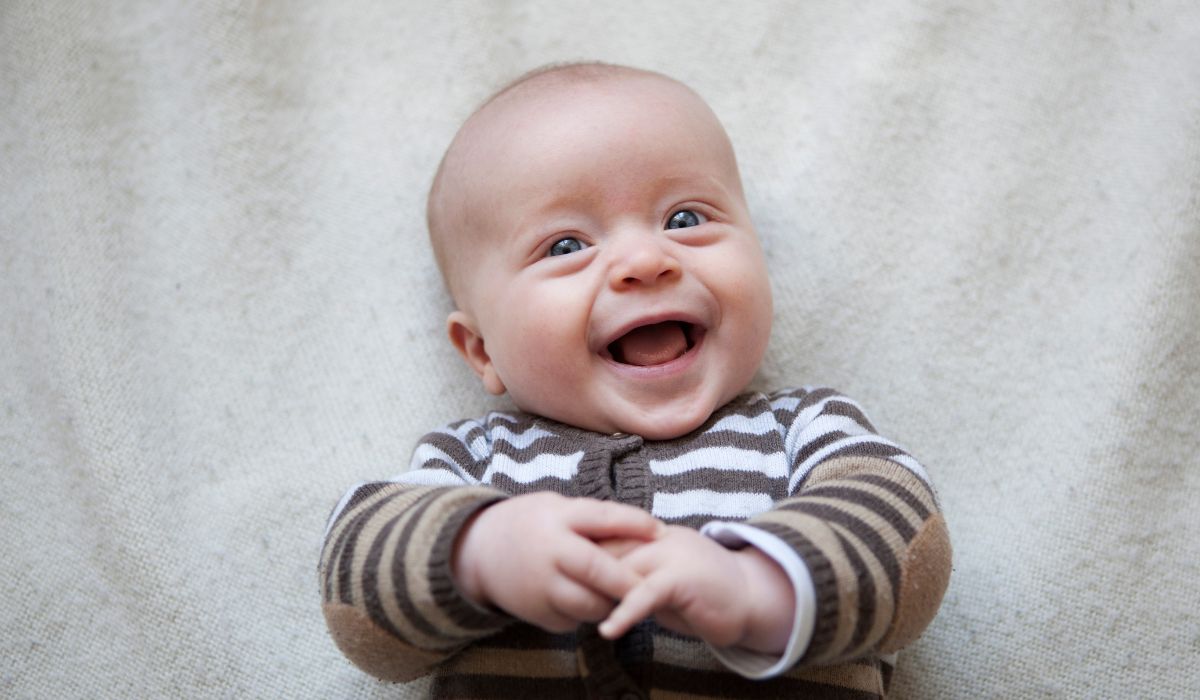 Baby boy smiling at the camera