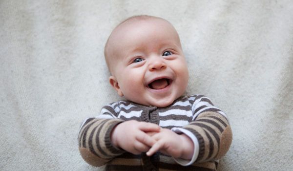Baby boy smiling at the camera