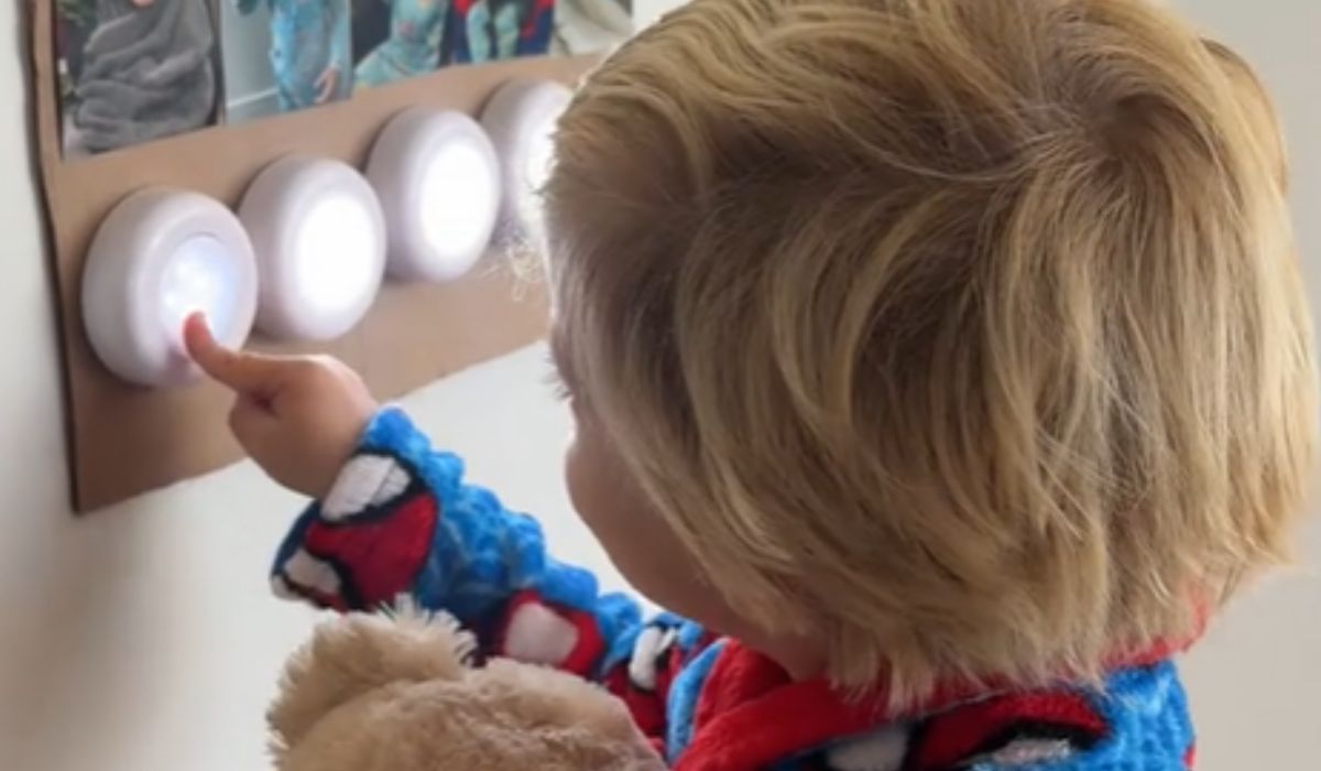 Child pressing buttons on a bedtime routine chart