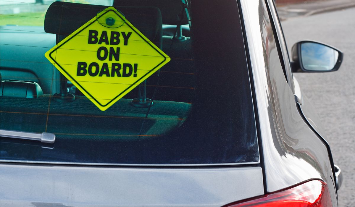 Baby on board sticker on rear window of car