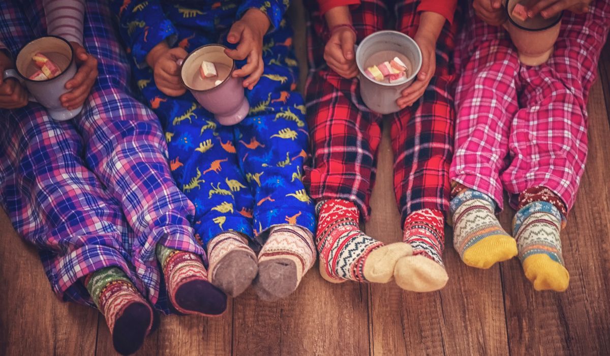 Children in pyjamas drinking hot chocolate at Christmas time