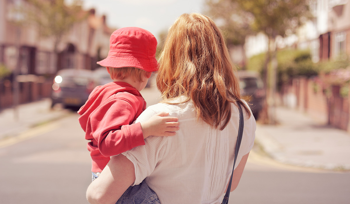 A mother carrying her young son. Pic: Getty Images