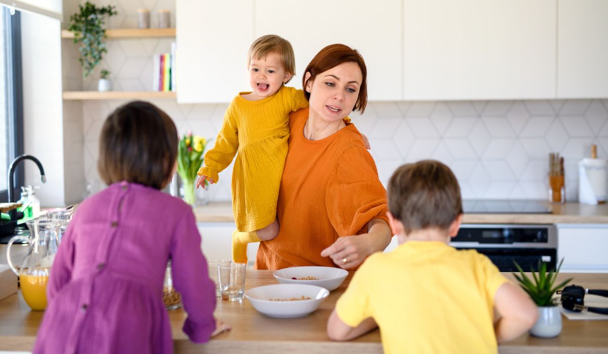 Mum giving children dinner