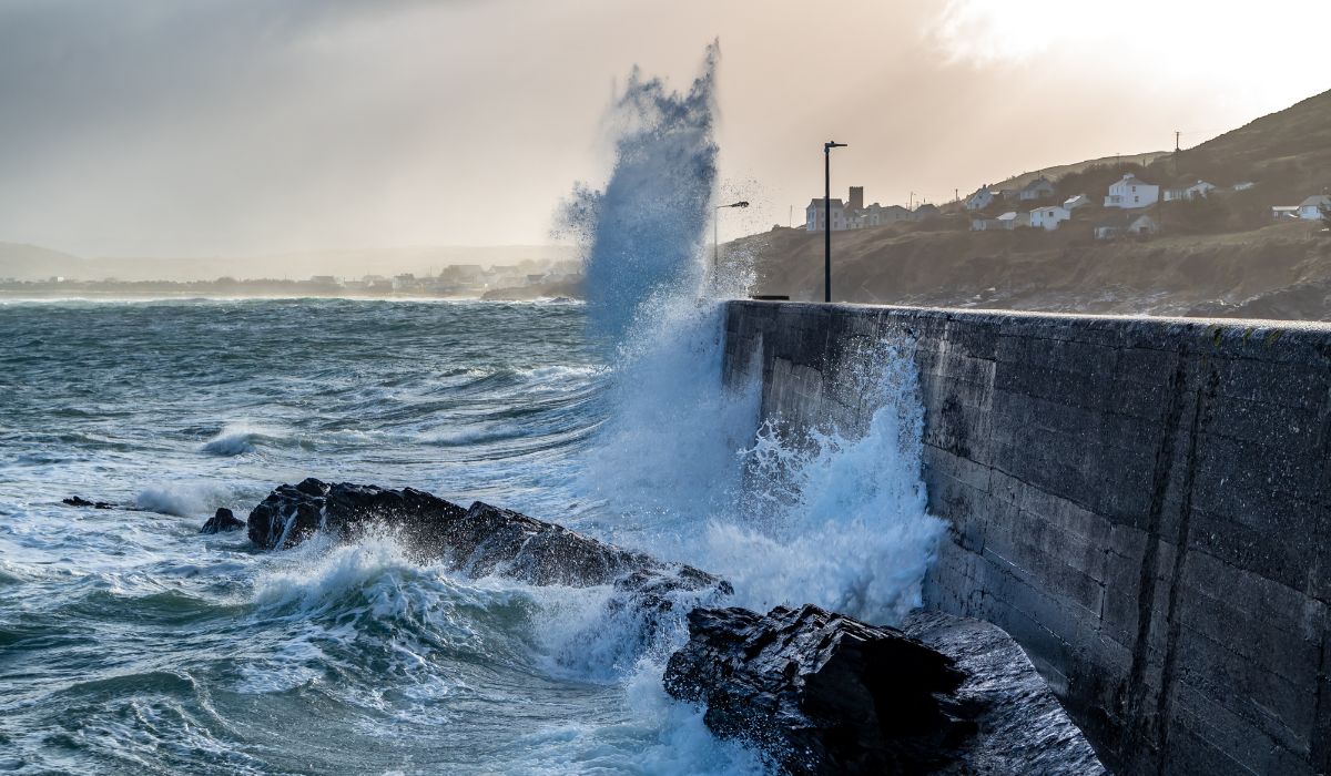 Waves crashing against the pier at Portnoo harbour after Storm Franklin - County Donegal, Republic of Ireland