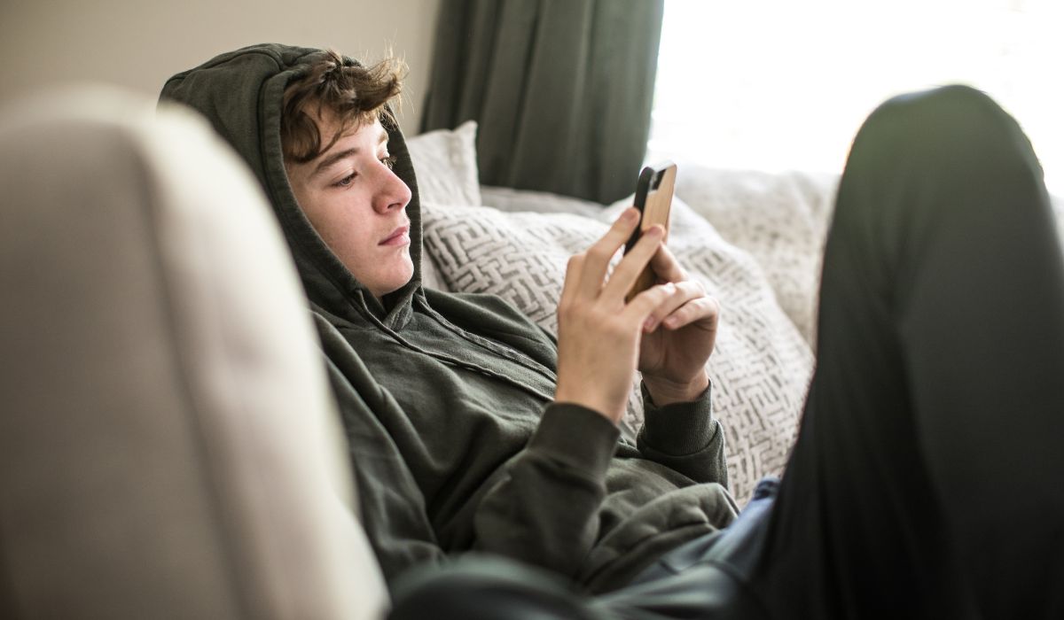 Teen boy looking at phone