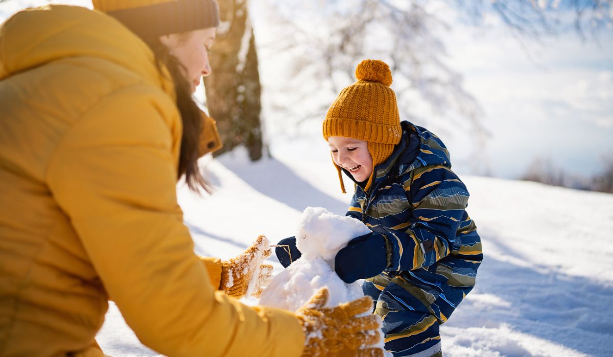 Mother playing with her son in snow