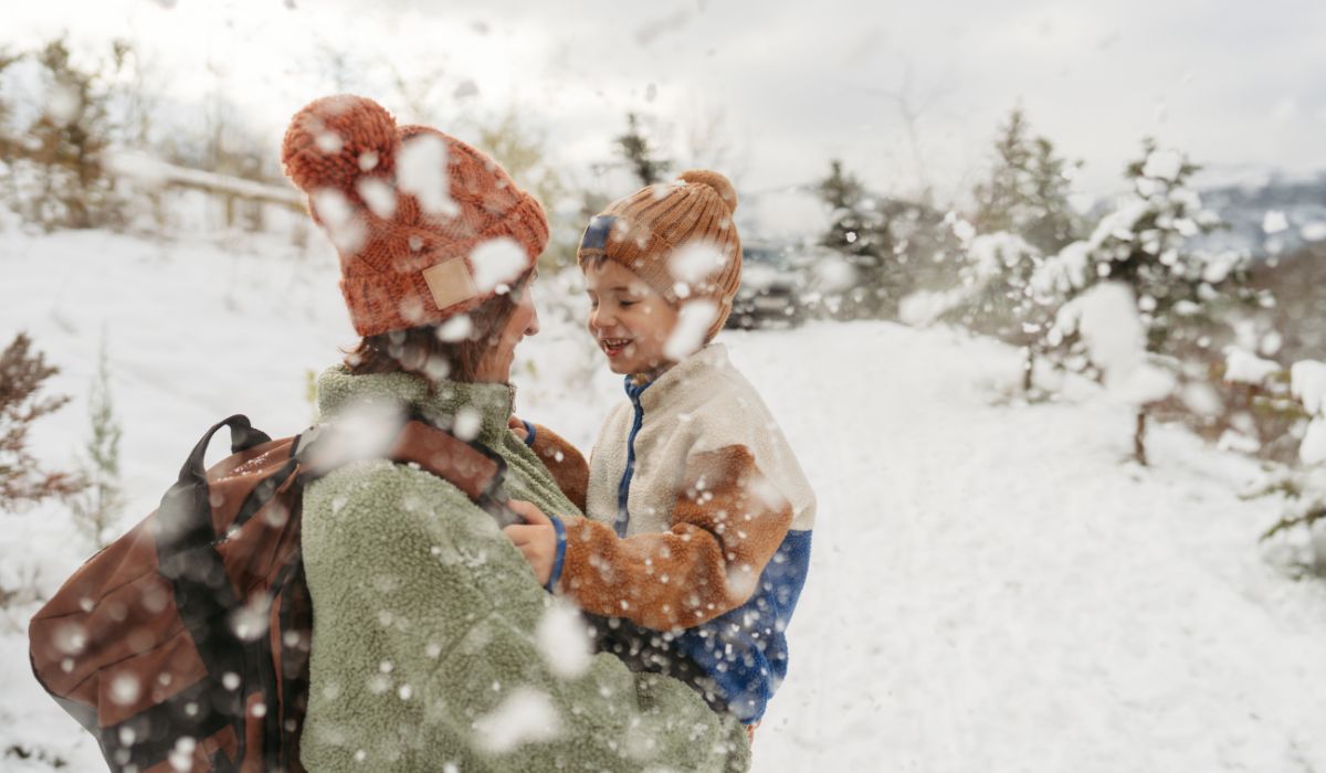 Mother playing with her son in the snow