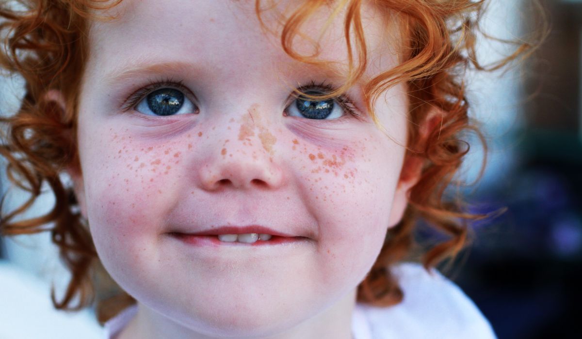 Cute little girl with red curly hair
