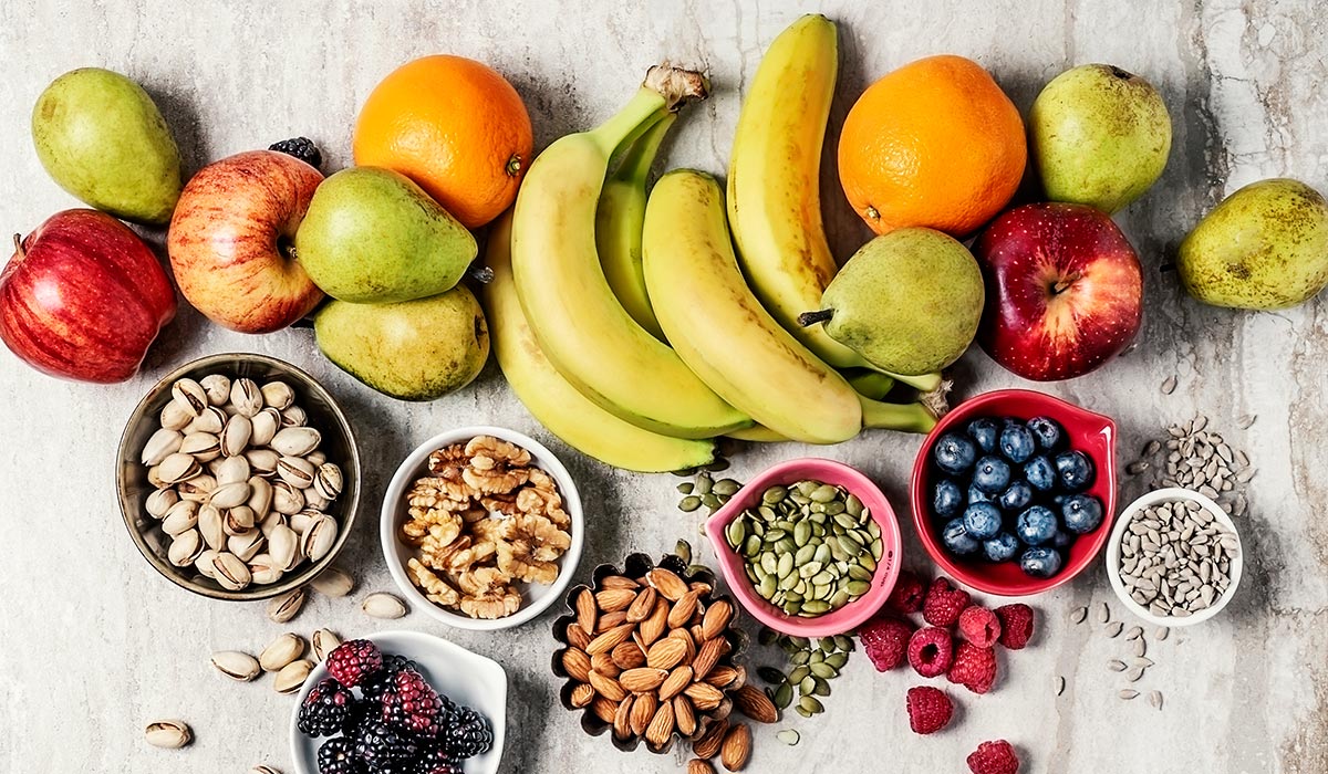 Variety of fruits and nuts on gray background