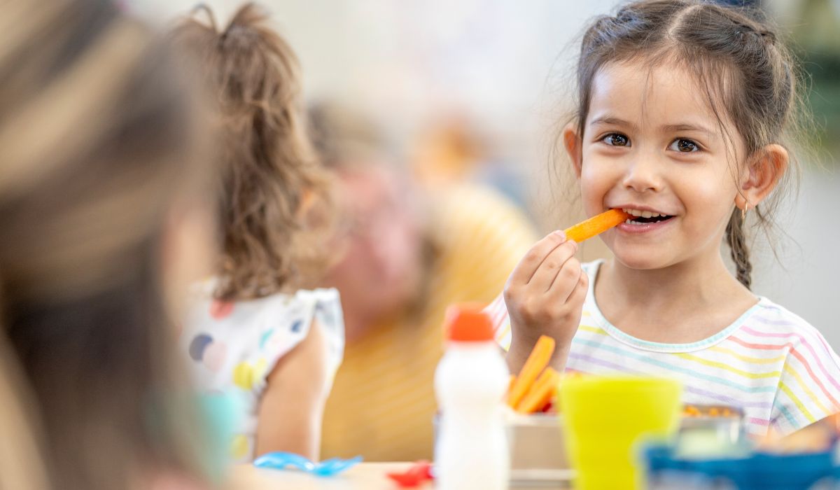 Girl eating carrots in school