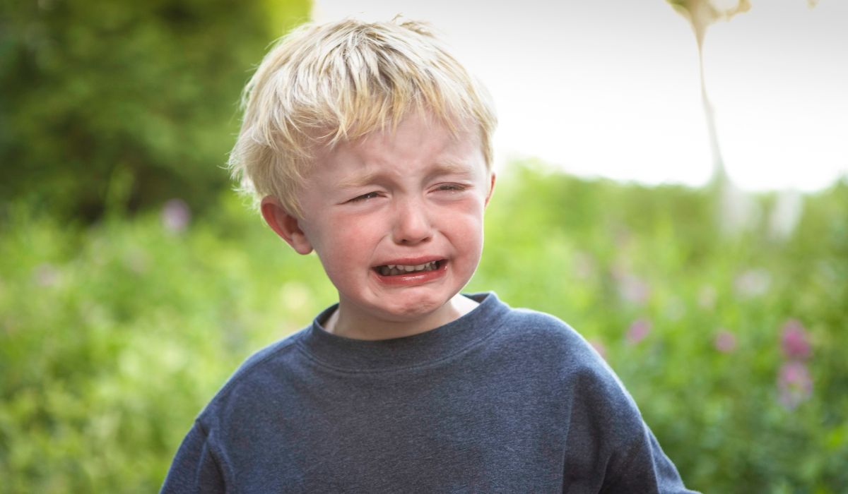 Little boy crying outside