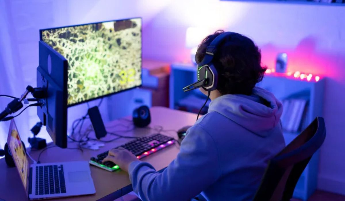 Boy playing video games on computer
