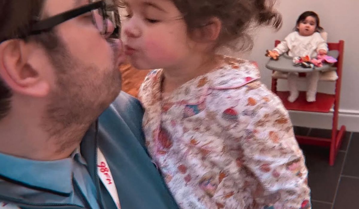 Brian Dowling kissing daughter Blake as Blu watches on in a high chair