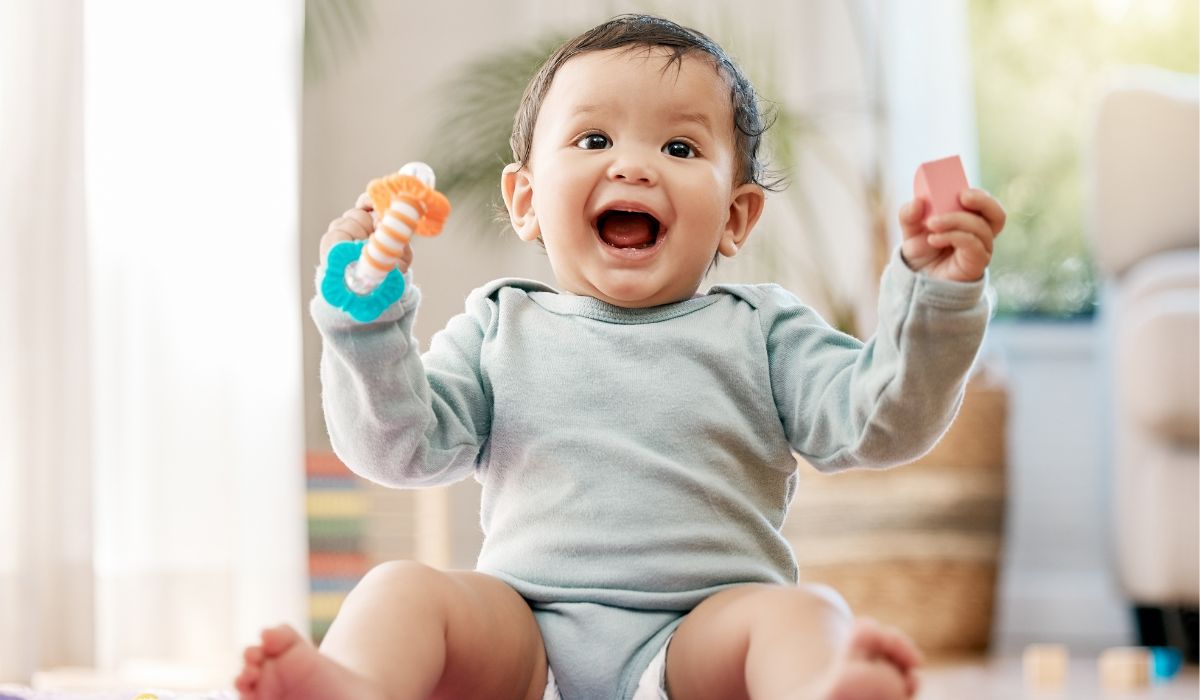 Baby boy with a rattle