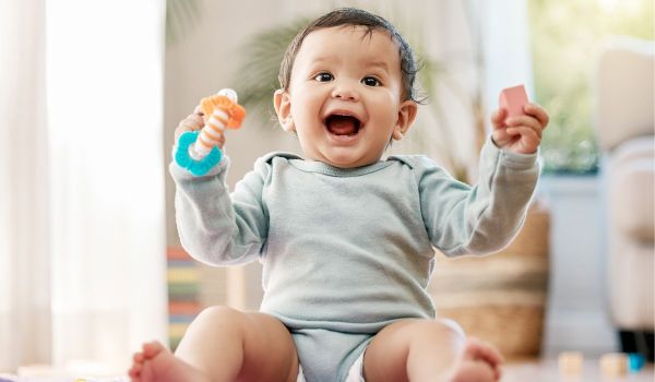 Baby boy with a rattle