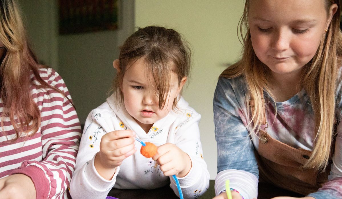 three kids doing arts and crafts