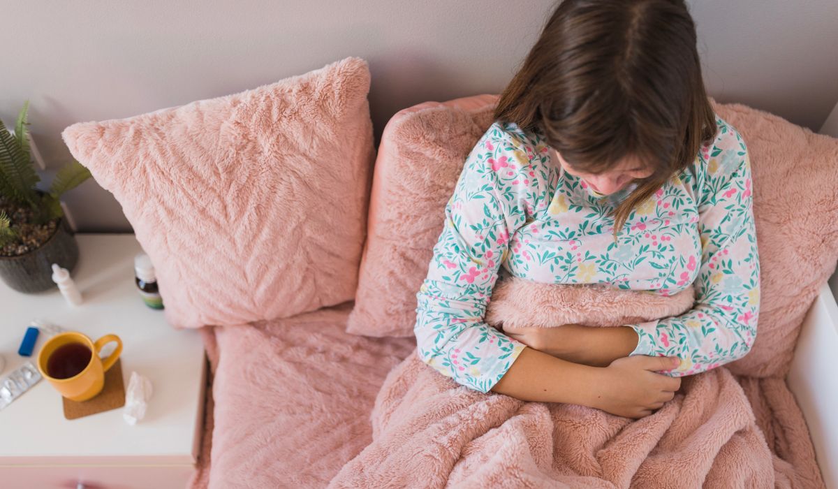 Little girl with stomach bug in bed