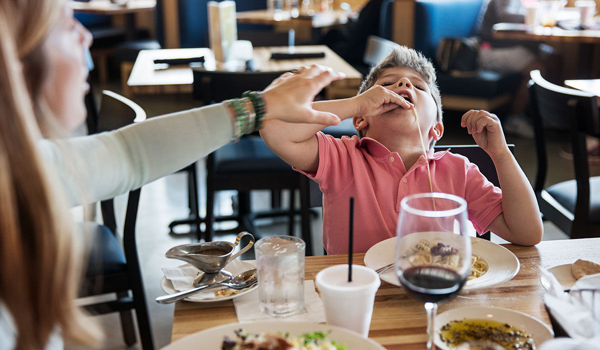 Mother stopping son eating noodles. Pic: Getty Images