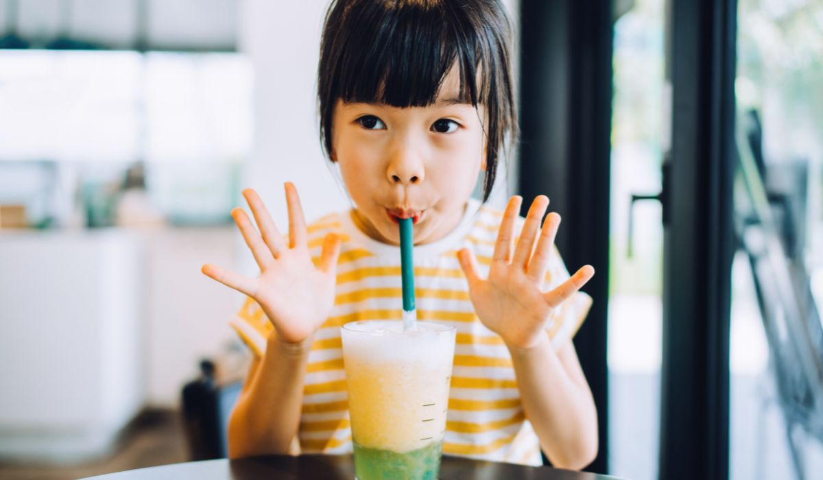 Little girl drinking slushie