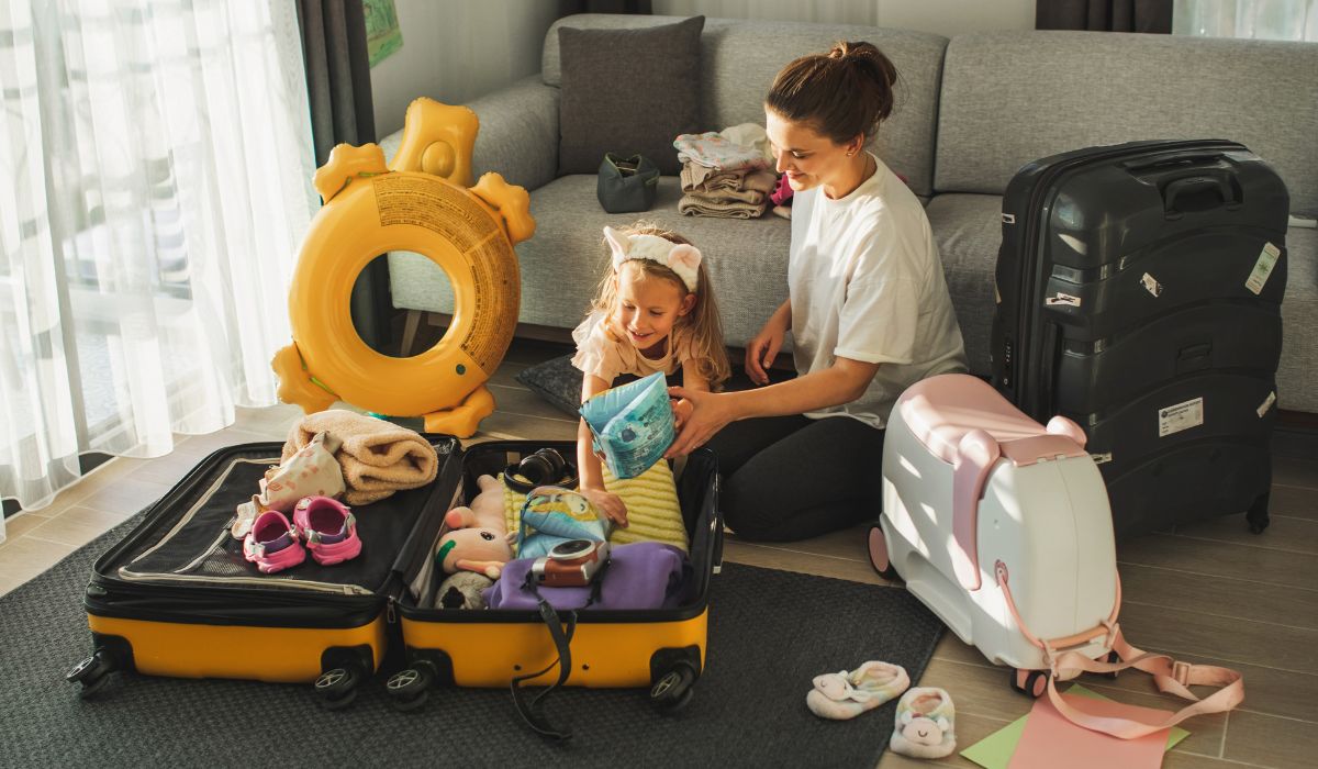 Mother packing daughter's suitcase (1)