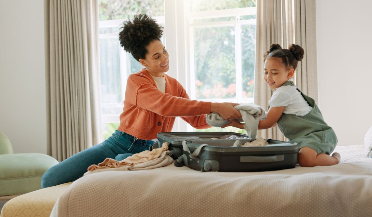 Mother packing daughter's suitcase (1)