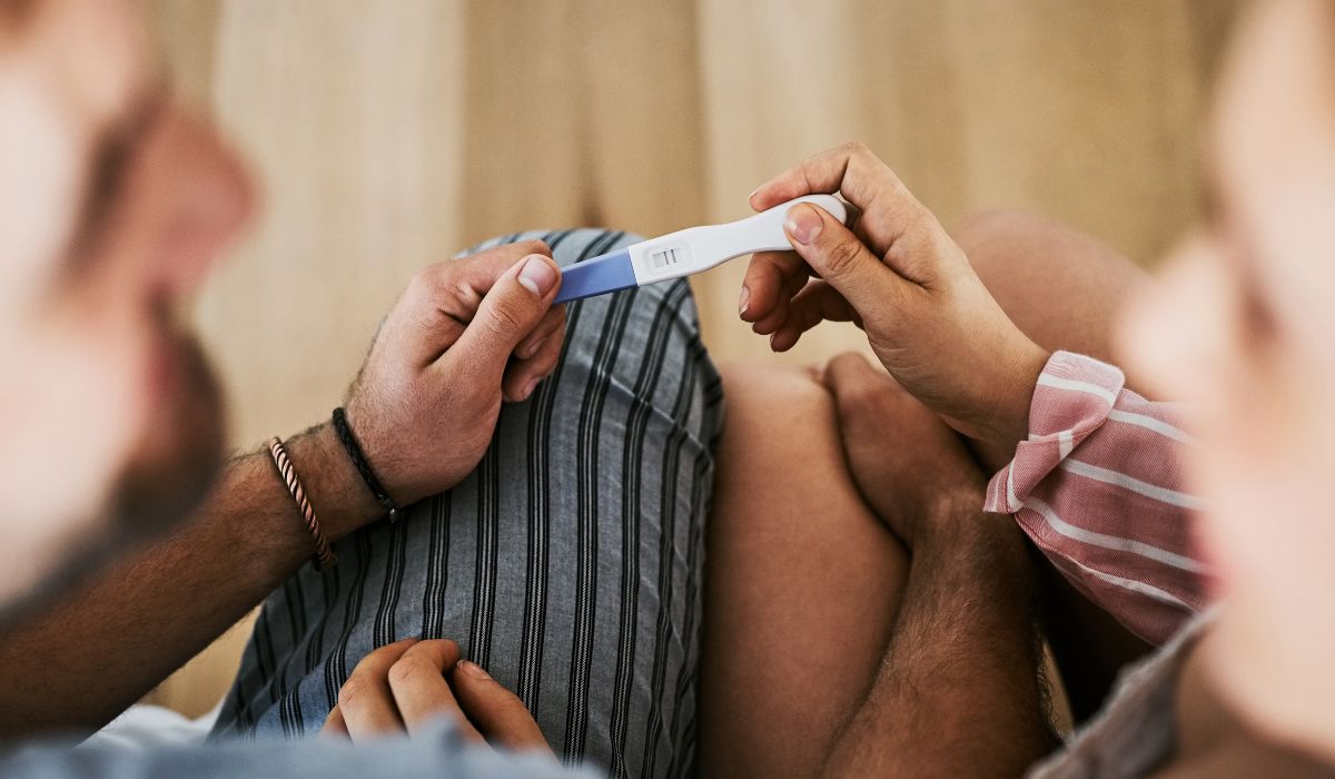 Couple holding positive pregnancy test