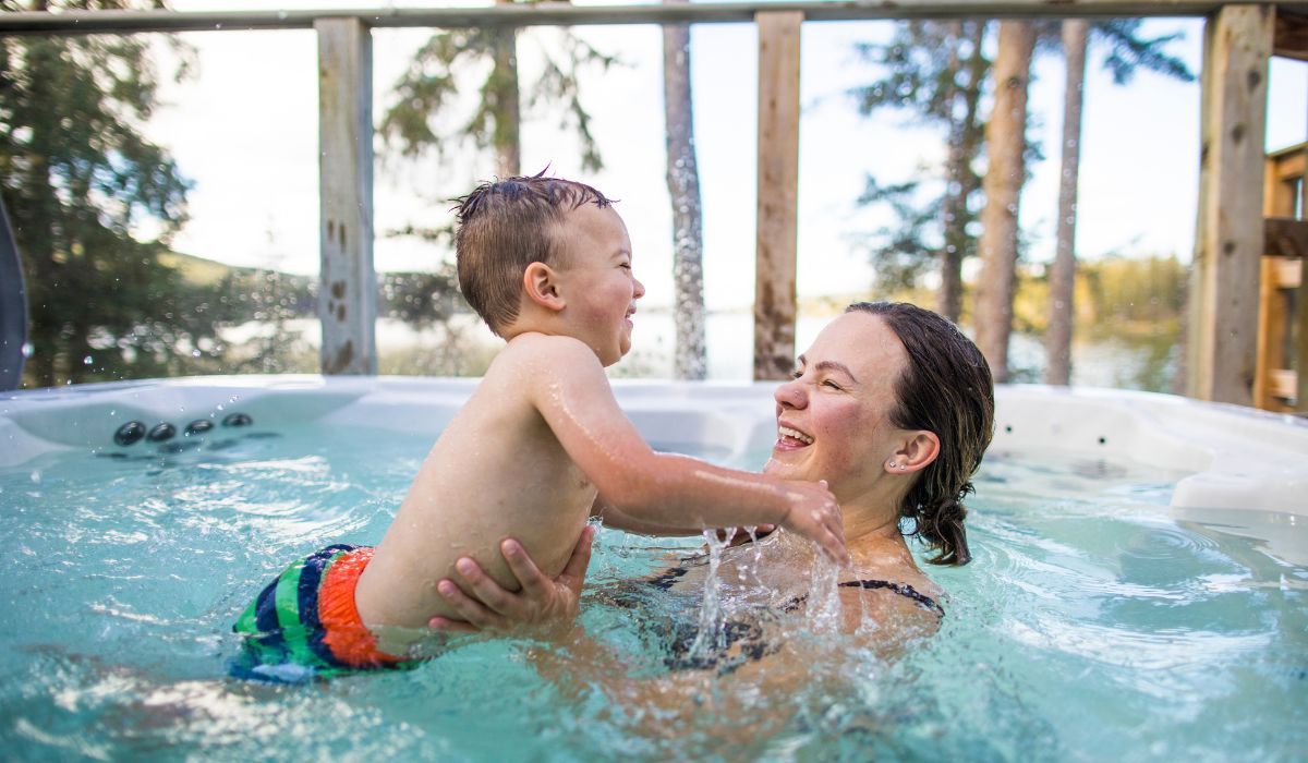Child in a hot tub with his mother