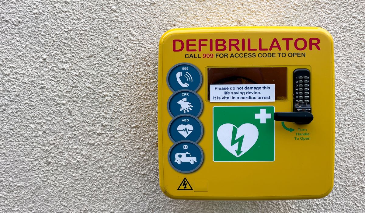 First aid heart defibrillator on a wall in a park in Cheltenham, UK