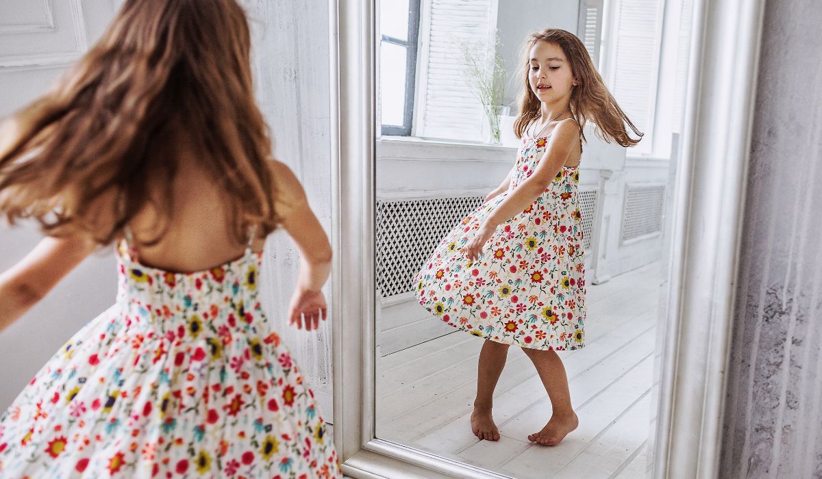 Little girl looking in mirror