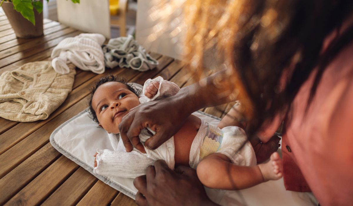 Parent changing baby's nappy.
