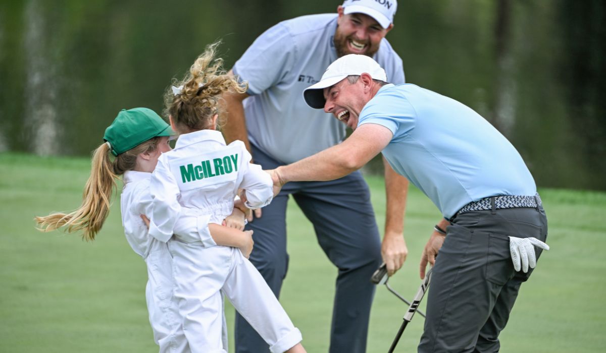 hane Lowry of Ireland, his daughter Iris, and Rory McIlroy of Northern Ireland celebrate the putt of McIlroy's daughter Poppy during the Par Three Contest prior to the Masters Tournament at Augusta National Golf Club on April 9, 2025 in Augusta, Georgia.