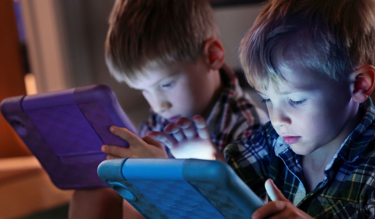 Boys playing on screens