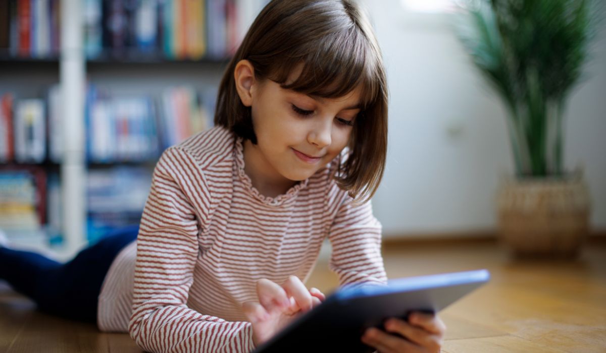 Young girl playing on tablet