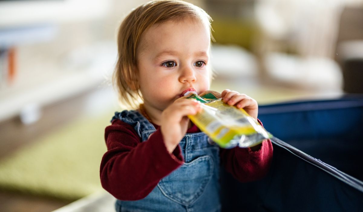 Baby eating food from pouch