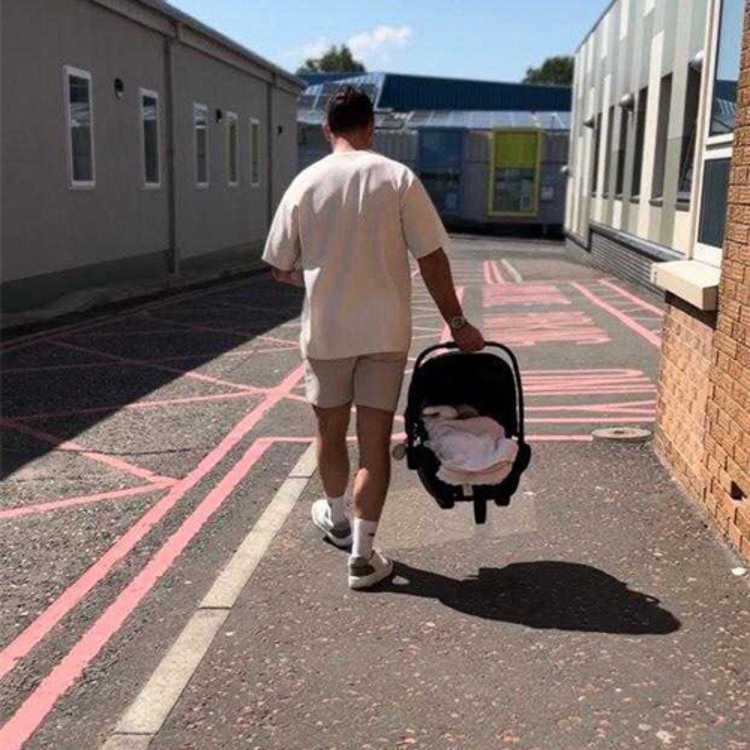 Darren McCarry carrying newborn out of the hospital