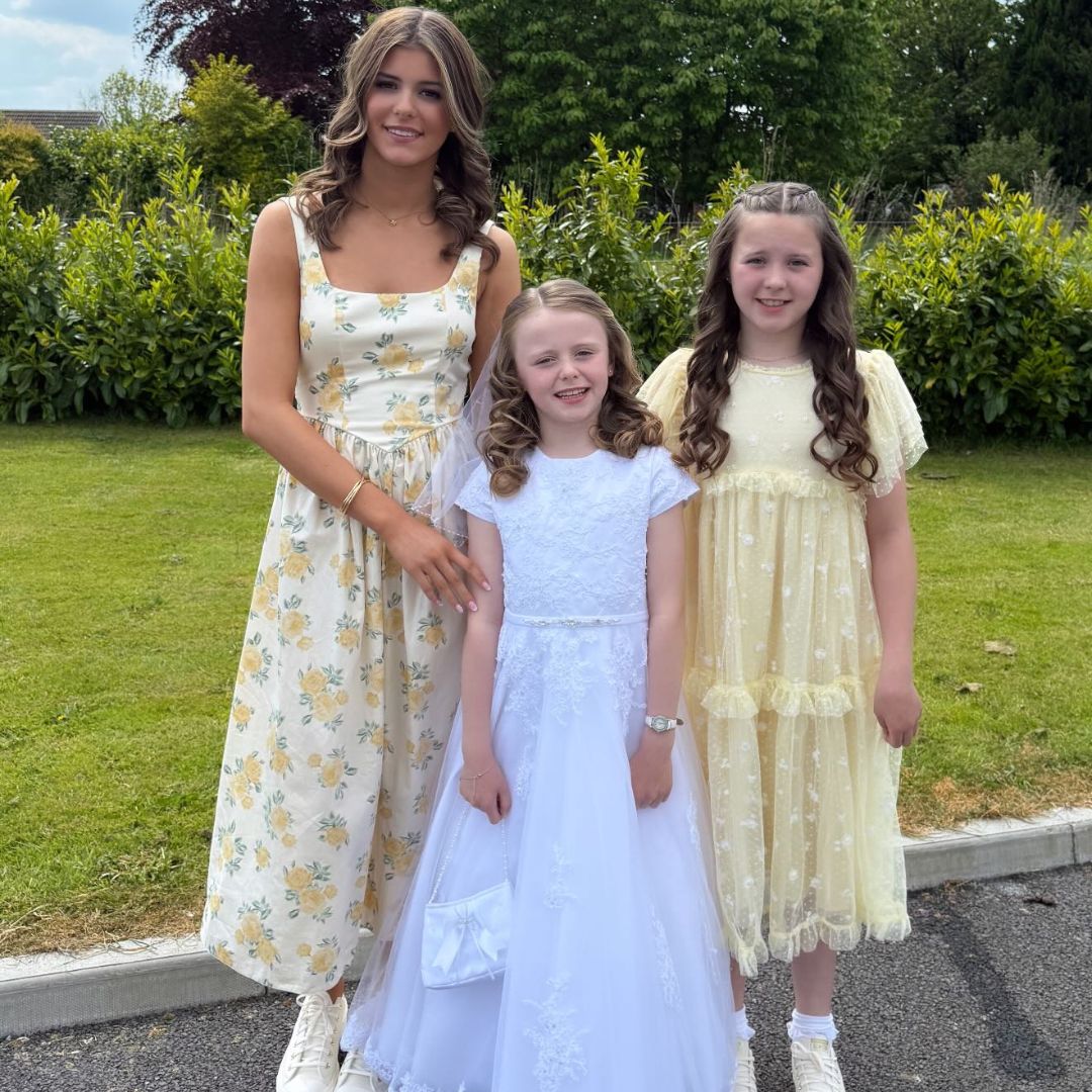 Rachel Gorry, Adrien and her youngest daughter cutting a communion cake
