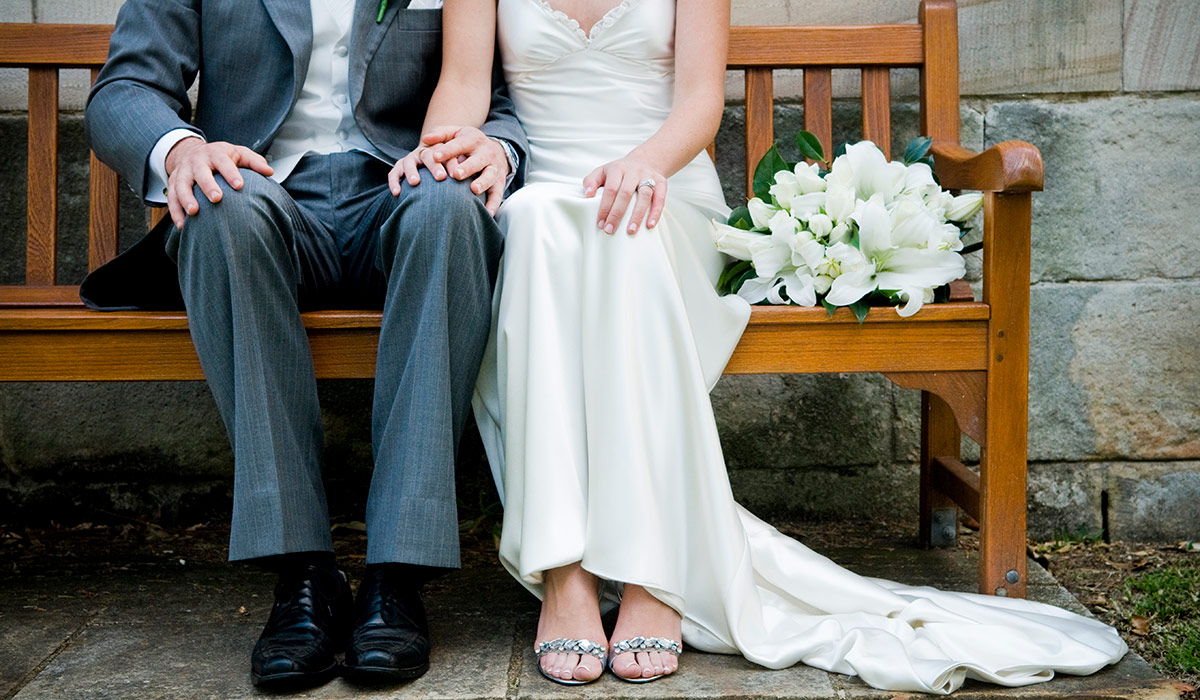 Bride and groom on bench