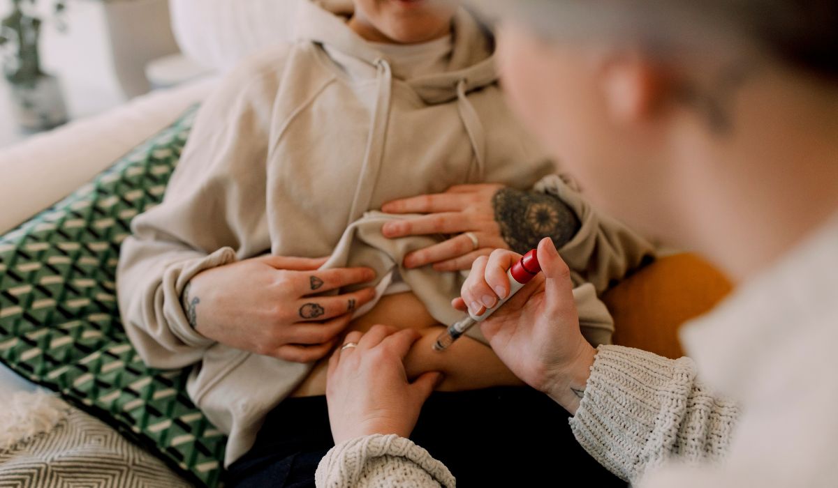 Man giving woman IVF injection