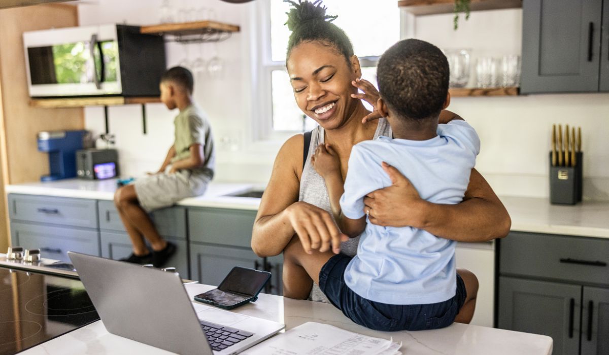 Mother working and holding son