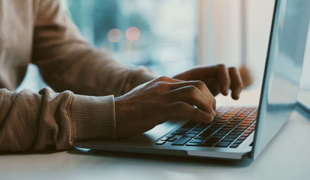 Person tying on computer (1)