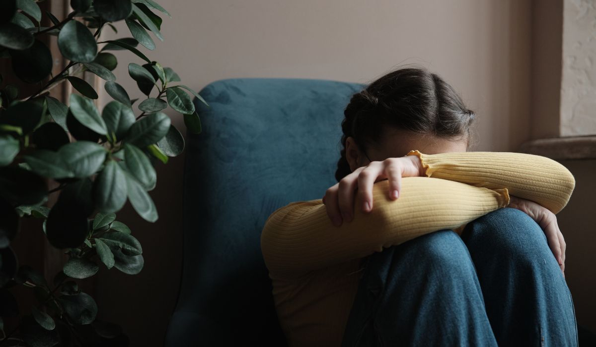 Sad teenager leaning on lap