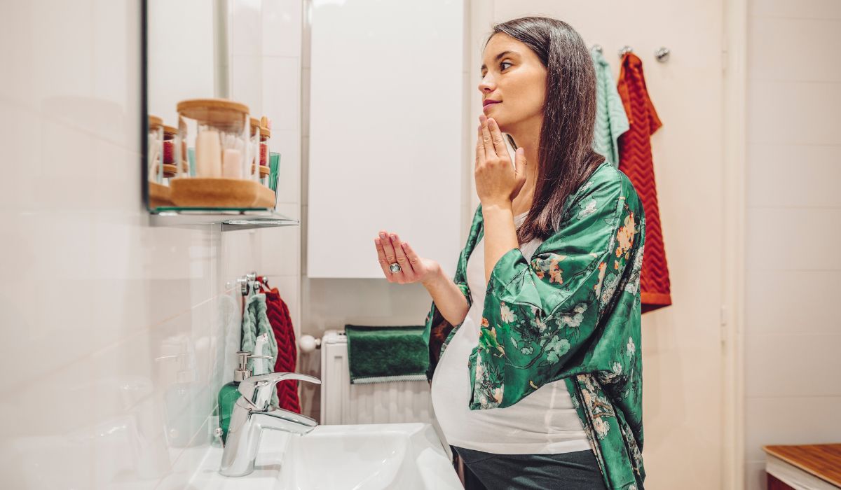 Pregnant woman doing skincare
