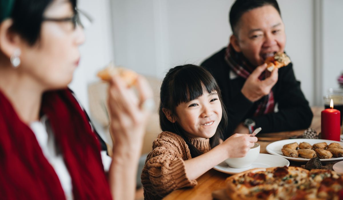 Child at the dinner table smiling