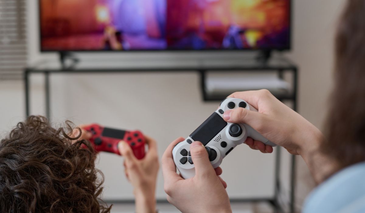 Playstation consoles in front of a TV