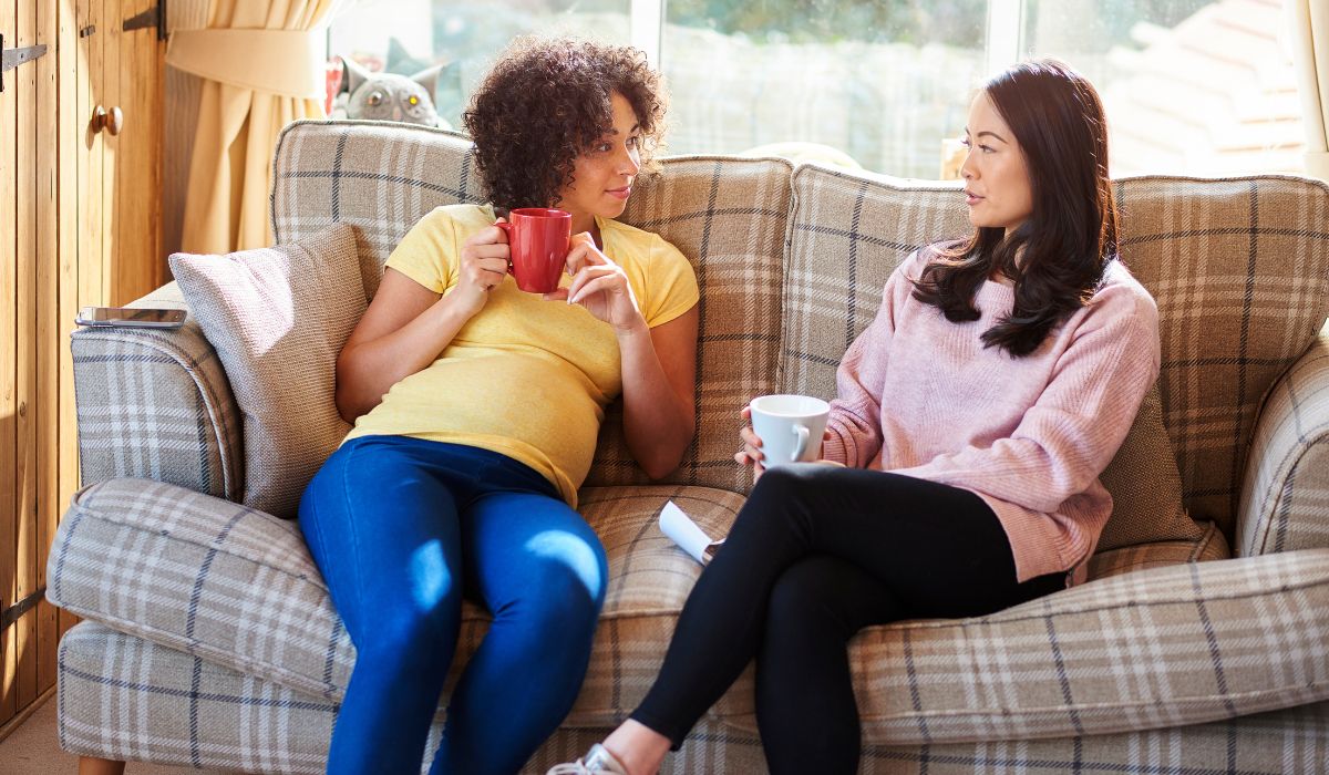 Pregnant woman on the couch with her friend