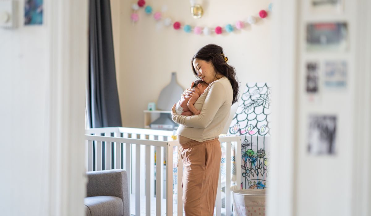 Mum holding her baby in a nursery