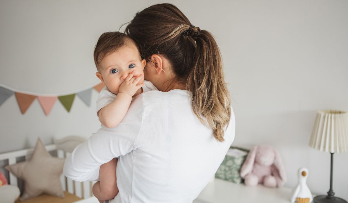 Mum holding her baby in a nursery