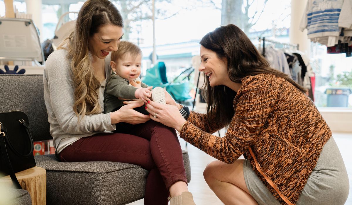 Woman trying shoes on a toddler