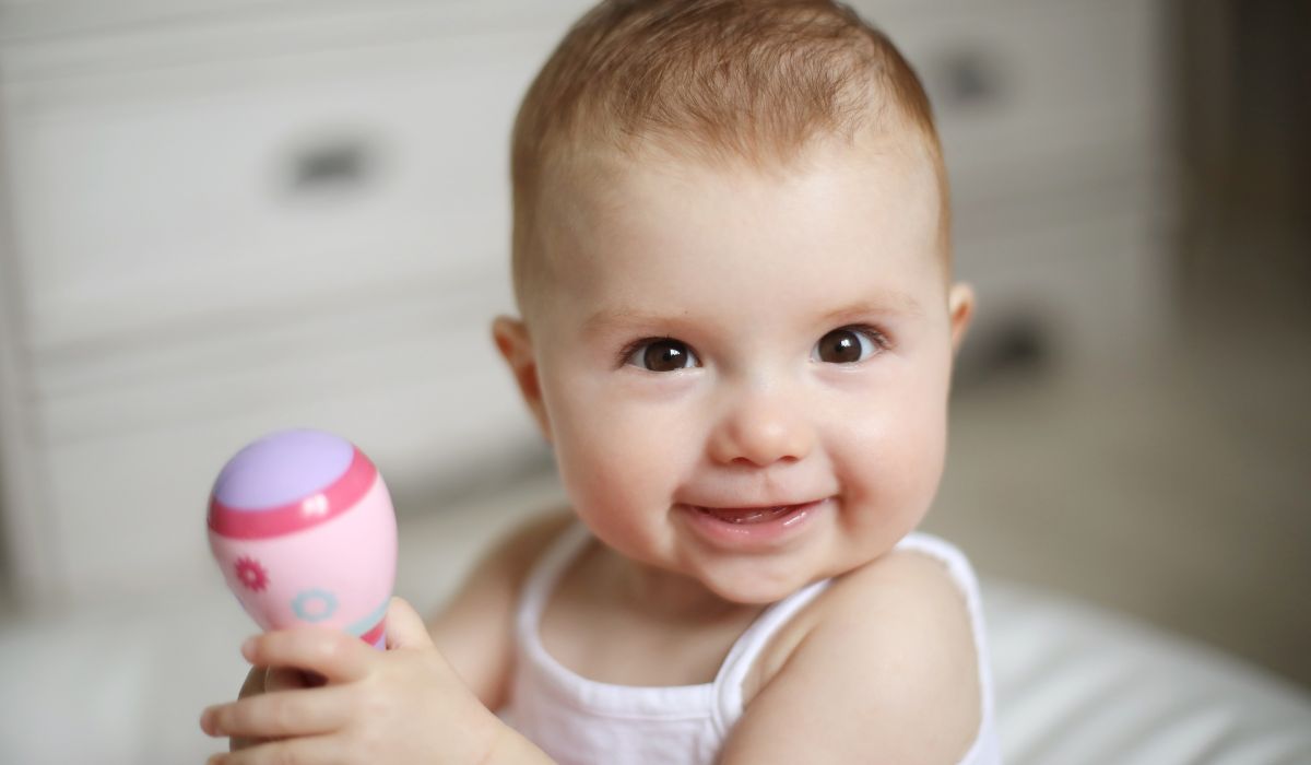 Baby girl with a rattle