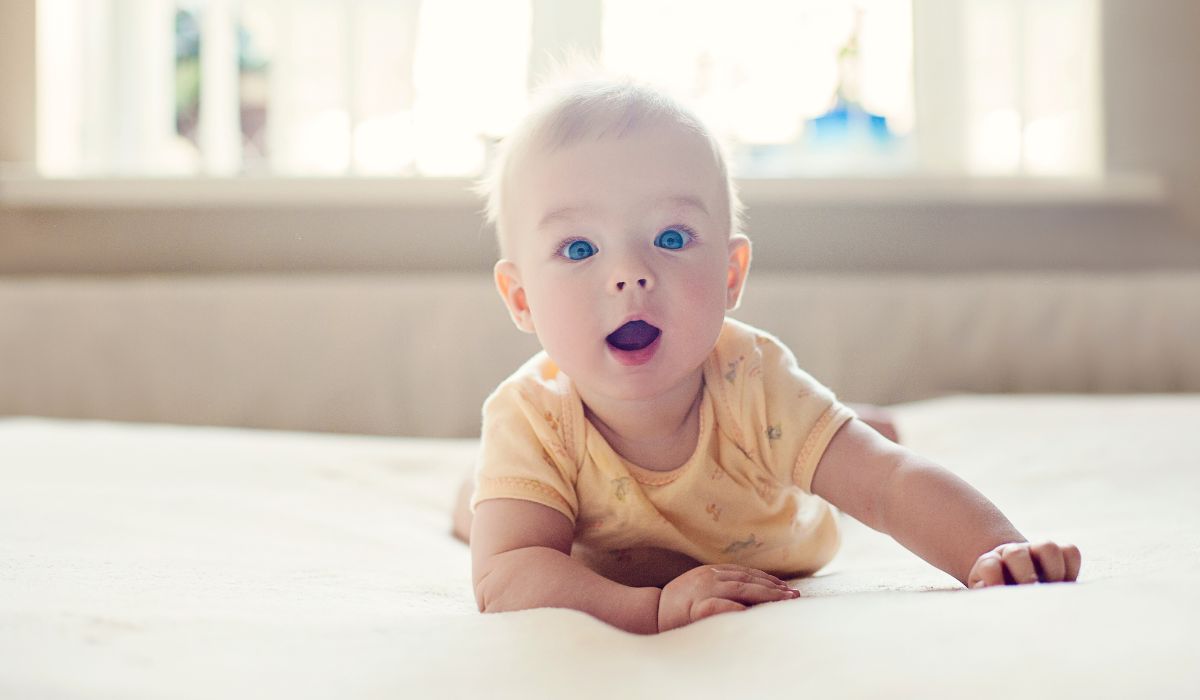Cute baby lying on bed